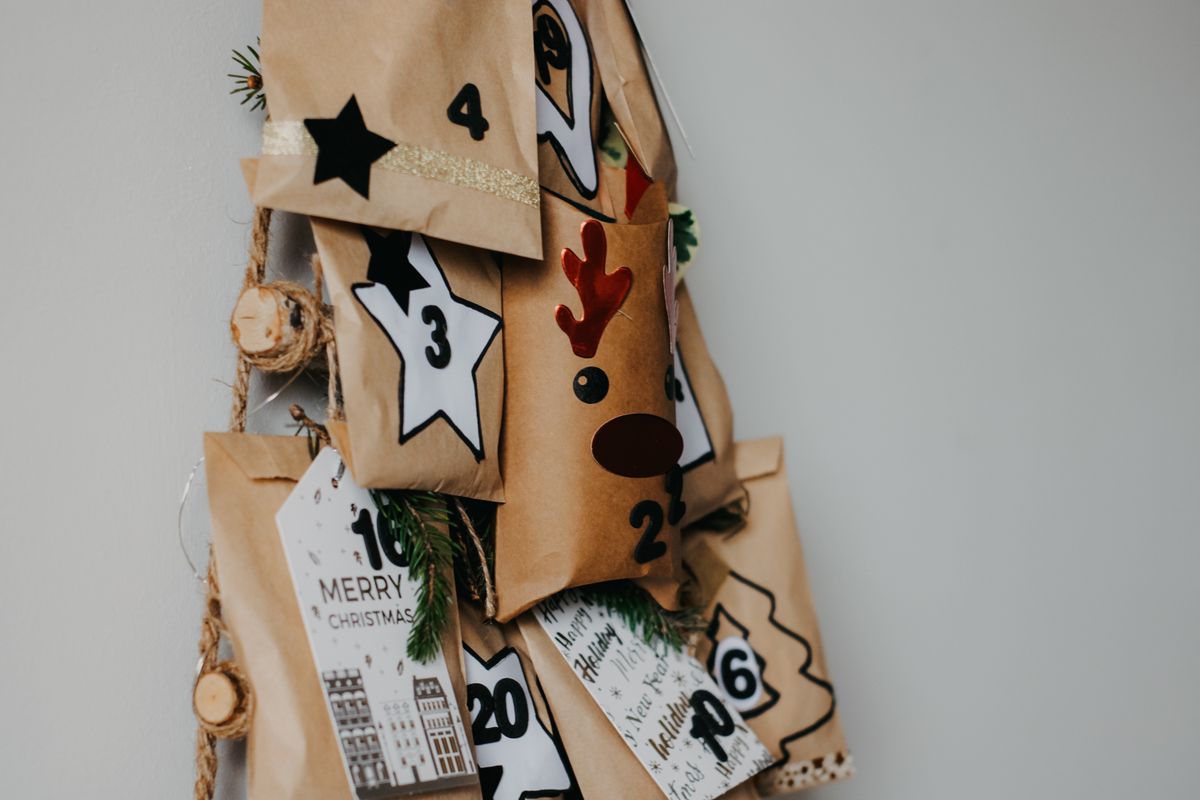 Homemade advent calendar made of numbered paper bags on a string