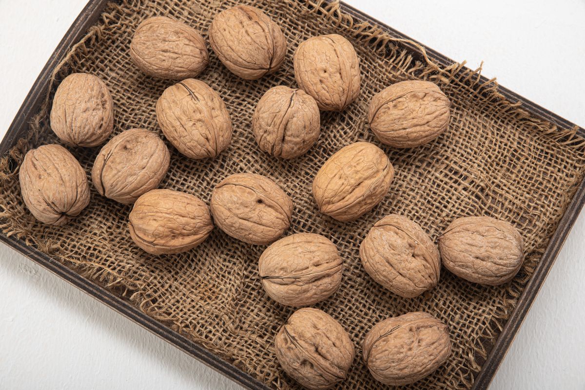 Whole walnuts in their shells on a tray